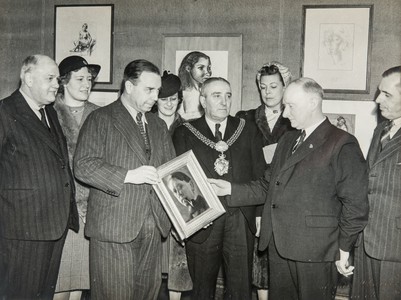The playwright, novelist and broadcaster J. B Priestley (left) presenting the RE self portrait from his collection to Bradford Art Gallery in 1943